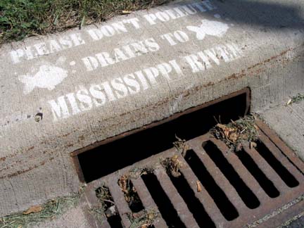 Storm drain with warning painted on it