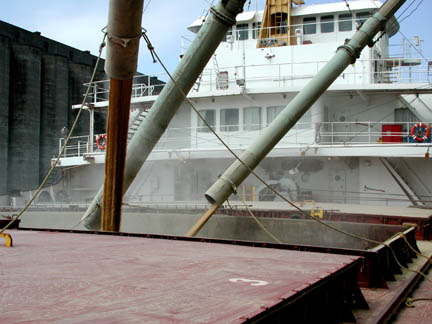 Grain spouts over hatch