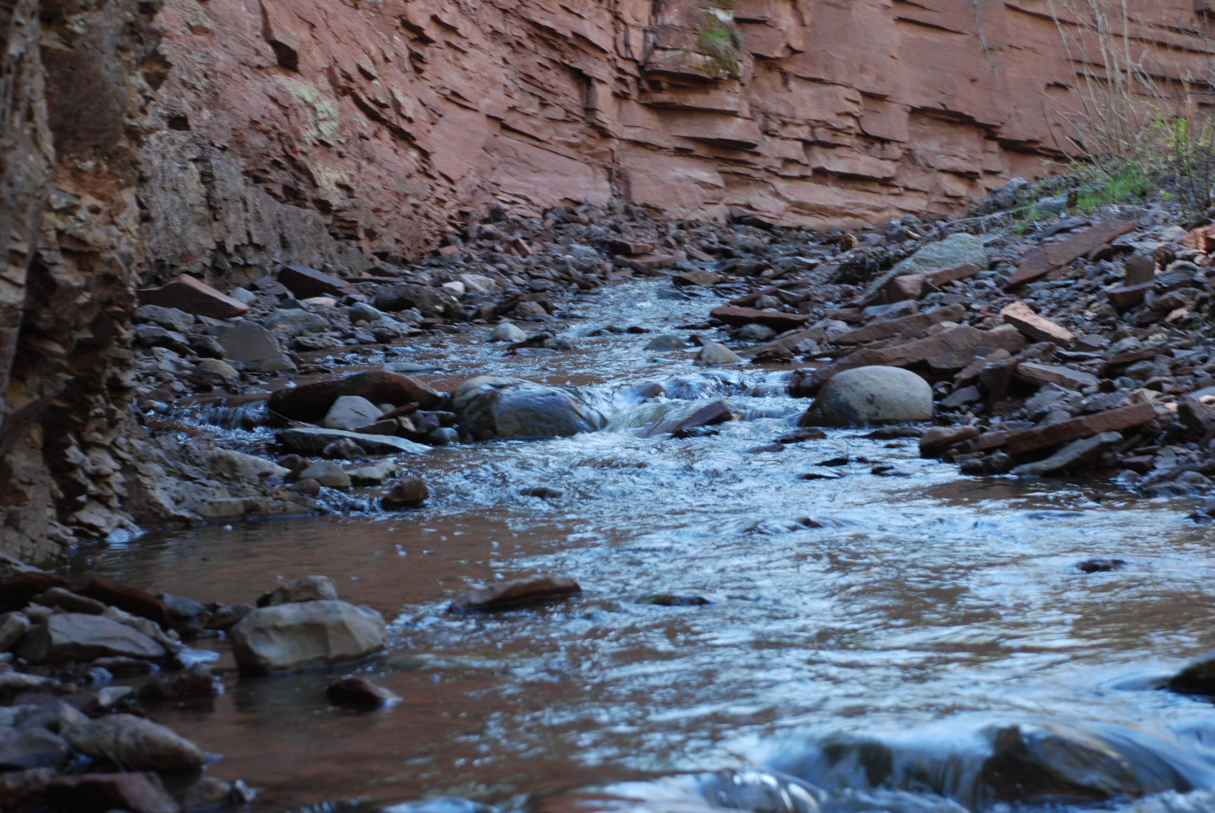 Creek winding around upthrust in rock